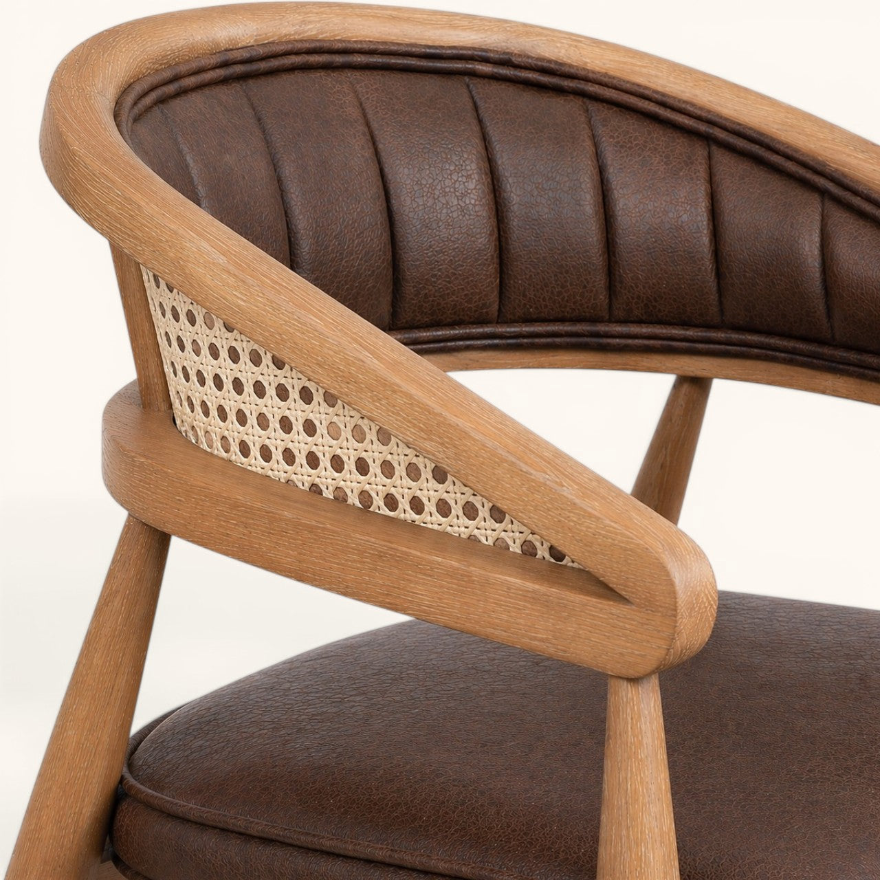 Eleganter Esszimmerstuhl aus Holz mit brauner Kunstlederpolsterung, geflochtener Rückenpartie und modernem Design.