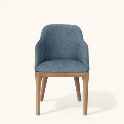 Stuhl mit hellbraunem Holzgestell und blau gepolsterter Sitzschale, hoher Rückenlehne und integrierten Armlehnen, moderner Designerstuhl für Wohnbereich und Esszimmer